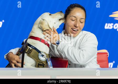 Jessica Pegula with dog Ace training for whom she is sponsoring speaks to press during US Open player media day ahead of start of tournament at Billy Jean King Tennis Center in New York on August 25, 2023 Stock Photo