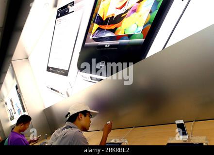 Bildnummer: 58171629  Datum: 02.07.2012  Copyright: imago/Xinhua (120702) -- SHANGHAI, July 2, 2012 (Xinhua) -- Citizens try products at an Apple store in Shanghai, east China, July 2, 2012. Apple Inc. has agreed to pay 60 million U.S. dollars Proview technology (Shenzhen) based in China to settle the dispute over the iPad trademark, the Higher People s Court of Guangdong Province announced Monday. (Xinhua/Chen Fei) (zhs) CHINA-SHANGHAI-IPAD TRADEMARK DISPUTE (CN) PUBLICATIONxNOTxINxCHN Wirtschaft Apple i Pad2 2 iPad2 xjh x0x premiumd 2012 quer      58171629 Date 02 07 2012 Copyright Imago XIN Stock Photo