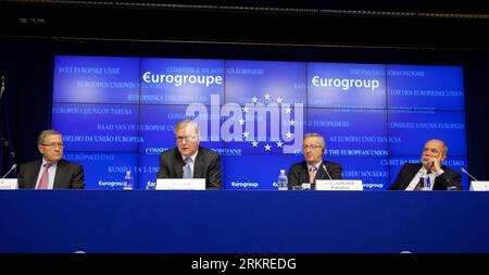 120710 -- BRUSSELS, July 10, 2012 Xinhua -- President of Eurogroup and Prime Minister of Luxembourg Jean-Claude Juncker 2nd R, EU Commissioner for Economic and Monetary Affairs Olli Rehn 2nd L and chief executive officer of the European Financial Stability Facility Klaus Regling 1st R attend a press conference after a Eurogroup finance ministers meeting in Brussels, capital of Belgium, on July 10, 2012. Eurozone finance ministers have agreed to grant the Spanish government one more year to reach a deficit target of 3 percent of its gross domestic product, Eurogroup President Jean-Claude Juncke Stock Photo