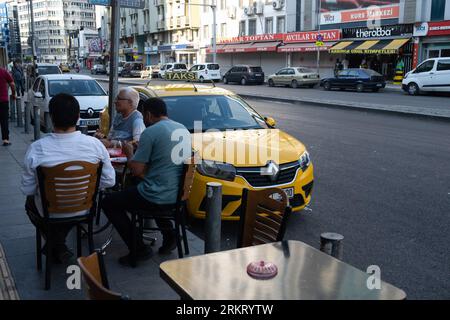 Izmir, Turkey. 20th Aug, 2023. People are seen sitting next to the taxi. It is showing the effect of hot weather in ?zmir. People took to the streets despite the hot weather. Credit: SOPA Images Limited/Alamy Live News Stock Photo