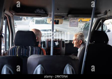 Izmir, Turkey. 20th Aug, 2023. Two people chatting in a car. It is showing the effect of hot weather in ?zmir. People took to the streets despite the hot weather. (Photo by Murat Kocabas/SOPA Images/Sipa USA) Credit: Sipa USA/Alamy Live News Stock Photo