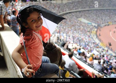 Bildnummer: 58561967  Datum: 06.10.2012  Copyright: imago/Xinhua A girl holds an Egyptian flag during a celebration ceremony for the 39th anniversary of the Oct.-6 war against Israel, at Cairo International Stadium in Cairo, Egypt, Oct. 6, 2012. Egypt on Saturday held a large celebration commemorating the 39th anniversary of the Oct.-6 war launched against Israel in 1973, which Egypt deems as a victorious feat that boosted the Arab countries morale. (Xinhua/Li Muzi) EGYPT-ISRAEL-OCT. 6-WAR-CELEBRATION PUBLICATIONxNOTxINxCHN Gesellschaft Militär Politik Jahrestag Oktoberkrieg Jom Kippu Krieg ar Stock Photo