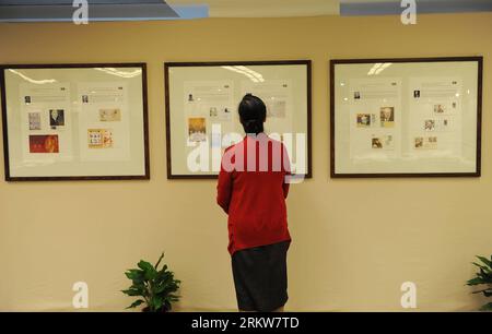 Bildnummer: 58633668  Datum: 25.10.2012  Copyright: imago/Xinhua (121025) -- SHANGHAI, Oct. 25, 2012 (Xinhua) -- A visitor looks at stamps displayed at a collection exhibition of Nobel Prize in Shanghai Putuo District Library, east China s Shanghai Municipality, Oct. 25, 2012. The exhibition opened here Thursday, displayed inscriptions, autographed books and photos, commemorative stamps from more than 300 winners of the Nobel Prize, including Chinese novelist Mo Yan s original manuscripts. Mo Yan is the winner of Nobel Prize in Literature 2012. (Xinhua/Lai Xinlin) (lx) CHINA-SHANGHAI-NOBEL PRI Stock Photo