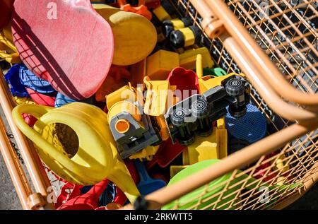 Potsdam, Germany. 25th Aug, 2023. Toys and watering cans lie ready in a box on the grounds of a daycare center. Credit: Jens Kalaene/dpa/Alamy Live News Stock Photo