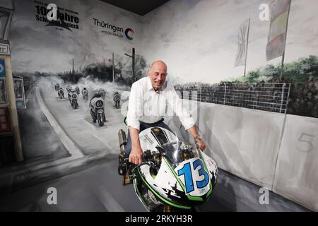 Schleiz, Germany. 26th Aug, 2023. Wolfgang Tiefensee (SPD), Minister of Economics in Thuringia, sits on a racing machine at the opening of the Motorwelt 'Schleizer Dreieck'. The Schleizer Dreieck is Germany's oldest road circuit and is still the venue for races in motor sports today. The museum will be dedicated to the hundred-year history of the racetrack. Credit: Bodo Schackow/dpa/Alamy Live News Stock Photo