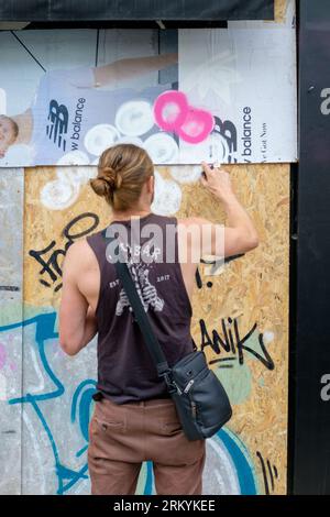 Graffiti-Aritisten Notting Hill Carnival 2023, London, UK. Künstler kommen aus ganz Großbritannien, um am Tag vor Beginn des Karnevals die Hordings zu malen. Quelle: Mary-Lu Bakker/Alamy Live News Stockfoto