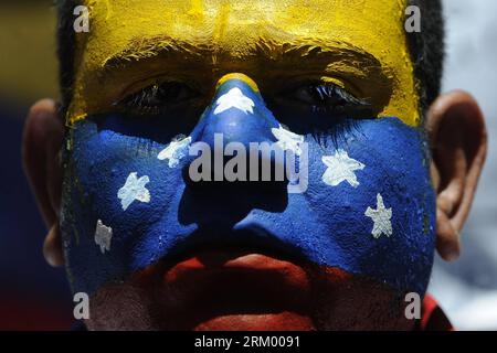 Bildnummer: 59295824  Datum: 03.03.2013  Copyright: imago/Xinhua (130303) -- CARACAS, March 3, 2013 (Xinhua) -- A man with the Venezuelan flag painted on his face attends a protest organized by students and opposers to the Venezuelan President Hugo Chavez in Caracas, capital of Venezuela, on March 3, 2013. Protestors demanded information about Chavez state of health. Venezuelan President Hugo Chavez was hospitalized at the Carlos Arvelo Military Hospital since Feb. 18, according to the local press. (Xinhua/Mauricio Valenzuela) VENEZUELA-CARACAS-PROTEST-CHAVEZ PUBLICATIONxNOTxINxCHN Politik Dem Stock Photo