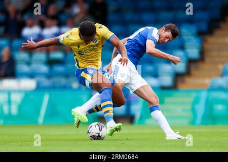 Gillingham's Ashley Nadesan and Colchester United's Nico Lawrence battle for the ball during the Sky Bet League Two match at Priestfield Stadium, Gillingham. Picture date: Saturday August 26, 2023. Stock Photo