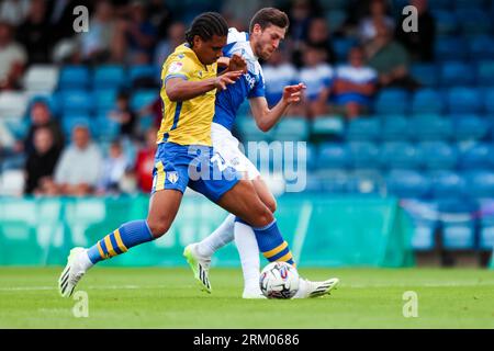 Gillingham's Ashley Nadesan and Colchester United's Nico Lawrence battle for the ball during the Sky Bet League Two match at Priestfield Stadium, Gillingham. Picture date: Saturday August 26, 2023. Stock Photo