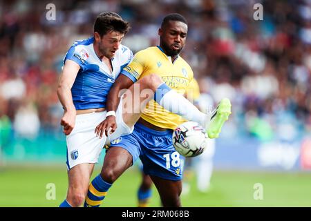 Gillingham's Ashley Nadesan and Colchester's Mandela Egbo battle for the ball during the Sky Bet League Two match at Priestfield Stadium, Gillingham. Picture date: Saturday August 26, 2023. Stock Photo