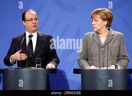 Bildnummer: 59371093  Datum: 18.03.2013  Copyright: imago/Xinhua (130319) -- BERLIN, March 19, 2013 (Xinhua) -- French President Francois Hollande (L) speaks as German Chancellor Angela Merkel looks on during a joint press conference prior to the European Round Table of Industrialists, at the Chancellery in Berlin, Germany, March 18, 2013. The leaders of Germany, France and the European Union Commission pledged to boost growth and competitiveness of the European economy at a meeting on Monday in the German capital. (Xinhua/Pan Xu) (lyx) GERMANY-BERLIN-EUROPEAN LEADERS-MEETING-PRESS CONFERENCE Stock Photo