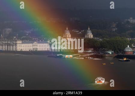 London, UK. 26th August, 2023. UK Weather: A massive rainbow breaks over River Thames with Old Royal Naval College in Greenwich in view as a brief afternoon rainstorm clears. Credit: Guy Corbishley/Alamy Live News Stock Photo