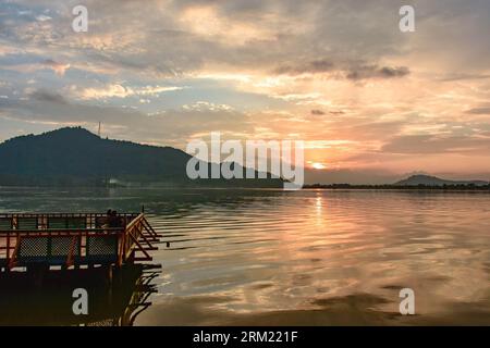 Srinagar, India. 26th Aug, 2023. A couple rests on the jetty during sunset in Srinagar, the summer capital of Jammu and Kashmir. (Photo by Saqib Majeed/SOPA Images/Sipa USA) Credit: Sipa USA/Alamy Live News Stock Photo