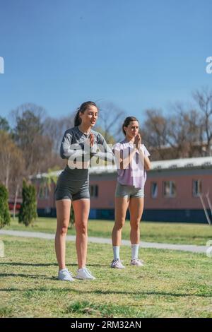 Ein Schuss von zwei Sportlerinnen, die vor dem Training grüßen Stockfoto