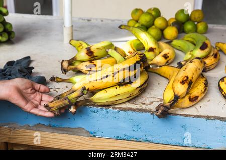 Big yellow bananas and passion fruits. Local fruits lay on a counter of a marketplace. Seychelle islands Stock Photo