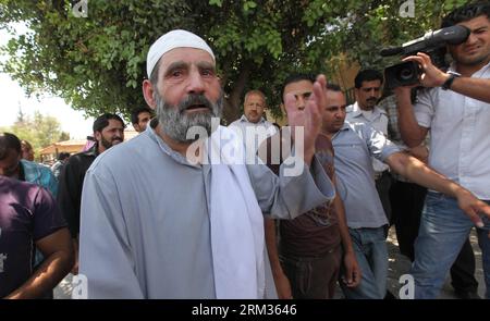 Bildnummer: 60041970  Datum: 07.07.2013  Copyright: imago/Xinhua (130707) -- AMMAN, July 7, 2013 (Xinhua) -- Mahmoud Othman Omar (front), father of radical Muslim cleric Abu Qatada, speaks to the media after his son leaves the State Security Court in Amman July 7, 2013. Jordan on Sunday detained radical Islamic cleric Abu Qatada upon arrival after he was deported from Britain, state-run Petra news agency reported. (Xinhua/Mohammad Abu Ghosh) (srb) JORDAN-AMMAN-RADICAL ISLAMIC CLERIC-DETAINMENT PUBLICATIONxNOTxINxCHN Gesellschaft Politik Islam Religion People x1x xdd premiumd 2013 quer o0 Famil Stock Photo