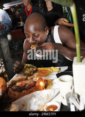 Bildnummer: 60084454  Datum: 09.07.2013  Copyright: imago/Xinhua (130709) -- NAIROBI, July 9, 2013 (Xinhua) -- A contestant takes part in a burger challenge at Brew Bistro in Nairobi, capital of Kenya, July 9, 2013. Four contestants had one hour to finish a 5kg burger with beef, two huge burger buns and 40 toppings. Sauti Sol team won the burger challenge. (Xinhua/Li Jing) KENYA-NAIROBI-BURGER CHALLENGE PUBLICATIONxNOTxINxCHN Gesellschaft Kultur Burgerwettessen Food Hamburger Burger Wettessen xdp x0x 2013 hoch premiumd      60084454 Date 09 07 2013 Copyright Imago XINHUA  Nairobi July 9 2013 X Stock Photo