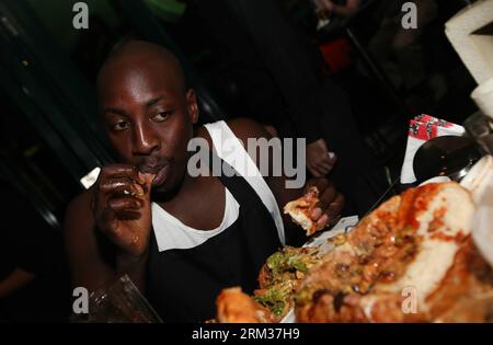 Bildnummer: 60084455  Datum: 09.07.2013  Copyright: imago/Xinhua (130709) -- NAIROBI, July 9, 2013 (Xinhua) -- A contestant takes part in a burger challenge at Brew Bistro in Nairobi, capital of Kenya, July 9, 2013. Four contestants had one hour to finish a 5kg burger with beef, two huge burger buns and 40 toppings. Sauti Sol team won the burger challenge. (Xinhua/Meng Chenguang) KENYA-NAIROBI-BURGER CHALLENGE PUBLICATIONxNOTxINxCHN Gesellschaft Kultur Burgerwettessen Food Hamburger Burger Wettessen xdp x0x 2013 quer premiumd      60084455 Date 09 07 2013 Copyright Imago XINHUA  Nairobi July 9 Stock Photo