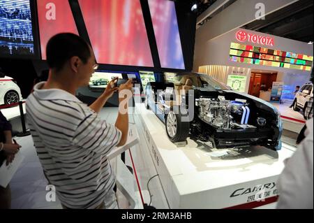 Bildnummer: 60119363  Datum: 13.07.2013  Copyright: imago/Xinhua (130713) -- CHANGCHUN, July 13, 2013 (Xinhua) -- A man takes pictures of a Toyota Camry hybrid car at the 10th China International Automobile Expo in Changchun, capital of northeast China s Jilin Province, July 13, 2013. Many automakers presented their new energy vehicles during the 10-day auto show, which kicked off on Friday. (Xinhua/Zhang Nan) (wjq) CHINA-JILIN-CHANGCHUN-AUTOMOBILE EXPO (CN) PUBLICATIONxNOTxINxCHN Wirtschaft Messe Auto Automesse xas x0x 2013 quer premiumd      60119363 Date 13 07 2013 Copyright Imago XINHUA  C Stock Photo