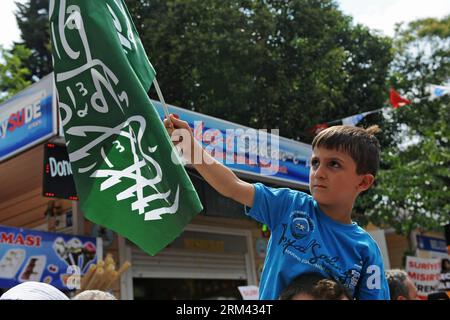 Bildnummer: 60363824  Datum: 16.08.2013  Copyright: imago/Xinhua (130816) -- ISTANBUL, Aug. 16, 2013 (Xinhua) -- A boy holds a flag during a demonstration to support ousted Egyptian President Mohamed Morsi in Istanbul, Turkey, Aug. 16, 2013. Almost two thousands supporters of ousted Egyptian President Mohamed Morsi gathered in the courtyard of Istanbul s Eyup Sultan Mosque for a demonstration to denounce the attacks of Egyptian military against civilians and a symbolic funeral prayer for the dead in Egypt. (Xinhua/Lu Zhe)(zhf) TURKEY-ISTANBUL-PROTEST-MORSI PUBLICATIONxNOTxINxCHN Politik Protes Stock Photo