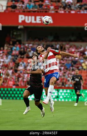 Granada, Spain. 26th Aug, 2023. Ignasi Miquel of Granada CF competes for the ball with Abdon Prats of RCD MAllorca during the Liga match between Granada CF and RCD Mallorca at Nuevo Los Carmenes Stadium on August 26, 2023 in Granada, Spain. (Photo by José M. Baldomero/Pacific Press) Credit: Pacific Press Media Production Corp./Alamy Live News Stock Photo