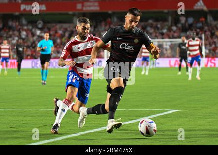 Granada, Granada, Spain. 26th Aug, 2023. Martin Valjent of RCD Mallorca drives the ball against Alberto Perea Correoso of Granada CF in action during the Liga match between Granada CF and RCD Mallorca at Nuevo Los Carmenes Stadium on August 26, 2023 in Granada, Spain. (Credit Image: © José M. Baldomero/Pacific Press via ZUMA Press Wire) EDITORIAL USAGE ONLY! Not for Commercial USAGE! Stock Photo