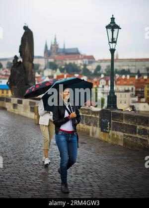 Bildnummer: 60460266  Datum: 02.09.2013  Copyright: imago/Xinhua  A young lady walks in rain on the Charles Bridge in Prague, capital of Czech Republic, on Sept. 2, 2013. As home to a number of famous cultural attractions, the extensive historic centre of Prague.(Xinhua/Zhou Lei) CZECH-PRAGUE-DAILY LIFE-A CITY FOR LOVERS PUBLICATIONxNOTxINxCHN Gesellschaft x2x xkg 2013 hoch o0 Karlsbrücke Brücke Regen     60460266 Date 02 09 2013 Copyright Imago XINHUA a Young Lady Walks in Rain ON The Charles Bridge in Prague Capital of Czech Republic ON Sept 2 2013 As Home to a Number of Famous Cultural attr Stock Photo