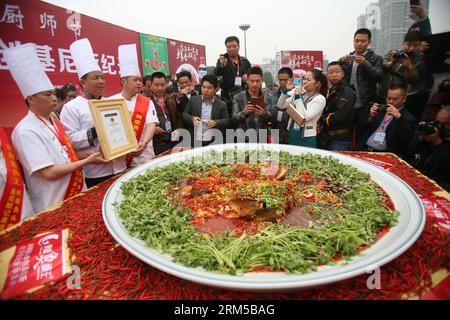 Bildnummer: 60615078  Datum: 19.10.2013  Copyright: imago/Xinhua (131019) -- CHANGSHA, Oct. 19, 2013 (Xinhua) -- Cooks present the China Records Certificate for the giant fish head with diced hot peppers, in Changsha, capital of central China s Hunan Province, Oct. 19, 2013. The 23rd Chinese Chef Festival kicked off in Changsha on Saturday. A giant dish of steamed fish head with diced hot peppers, a famous dish of Hunan cuisine, was cooked and presented to visitors at the opening ceremony. (Xinhua/Li Ga) (zgp) CHINA-CHANGSHA-GIANT DISH-STEAMED FISH HEAD WITH HOT PEPPERS (CN) PUBLICATIONxNOTxIN Stock Photo