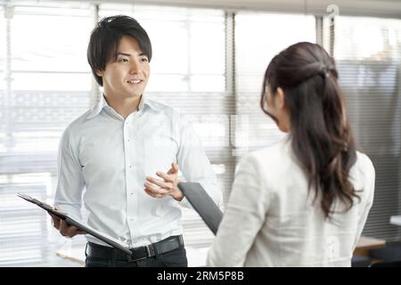 Asiatischer Geschäftsmann erklärt Arbeitsverfahren Stockfoto