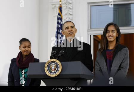 Bildnummer: 60764606  Datum: 27.11.2013  Copyright: imago/Xinhua     (131127) -- WASHINGTON D.C., Nov. 27, 2013 (Xinhua) -- U.S. President Barack Obama (C), with daughters Sasha (L) and Malia, carries on saving turkey Popcorn from the dinner table during the Thanksgiving tradition of presidential pardon in the Rose Garden of the White House in Washington D.C., the United States, on Nov. 27, 2013. (Xinhua/Fang Zhe) US-OBAMA-TURKEY-PARDON PUBLICATIONxNOTxINxCHN Politik people xas x2x 2013 quer o0 Familie Kind Tochter privat Stock Photo
