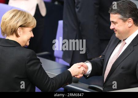 131217 -- BERLIN, Dec. 17, 2013 Xinhua -- German Chancellor Angela Merkel L shakes hands with German Vice-Chancellor and Minister of Economics and Energy Sigmar Gabriel during the meeting of Bundestag, Germany s lower house of parliament, in Berlin, Germany on Dec. 17, 2013. German new government headed by Chancellor Angela Merkel was sworn into office on Tuesday to rule Europe s biggest economy for the next four years. Cabinet ministers of the new coalition government, are formed by Merkel s Christian Democratic Union CDU, its Bavarian sister party Chrisitian Social Union CSU, and the Social Stock Photo