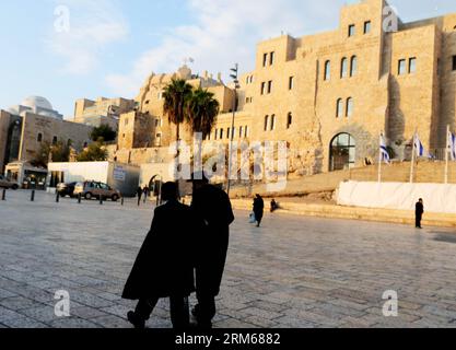 JERUSALEM, Dec. 17, 2013 (Xinhua) -- People walk in the Old City of Jerusalem Nov. 17, 2013. Jerusalem, one of the oldest cities in the world, is holy to the three major Abrahamic religions - Judaism, Christianity and Islam. Israelis and Palestinians both claim Jerusalem as their capital, as Israel maintains its primary governmental institutions here. The Old City of Jerusalem has been traditionally divided into four quarters, namely the Armenian, Christian, Jewish and Muslim quarters. It became a world heritage site in 1981, and is on the List of World Heritage in Danger. (Xinhua/Li Ying) JER Stock Photo