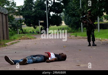 (131230) -- KINSHASA, Dec. 30, 2013 (Xinhua) -- A militant s body is seen on a road of Kinshasa, DR Congo, Dec. 30, 2013. Clashes happening Monday morning in Kinshasa have almost come to an end. The government has had the situation under control. At least 40 attackers who took part in multiple gunfights in the city were killed, said a government source. (Xinhua/Wang Bo) DR CONGO-KINSHASA-CLASHES PUBLICATIONxNOTxINxCHN   Kinshasa DEC 30 2013 XINHUA a militant S Body IS Lakes ON a Road of Kinshasa Dr Congo DEC 30 2013 clashes happening Monday Morning in Kinshasa have Almost Come to to End The Go Stock Photo