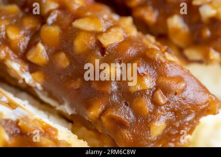Käsekuchen aus weichem Frischkäse und Erdnüssen in gesalzenem Karamell, süßes Dessert in Stücke geschnitten Stockfoto