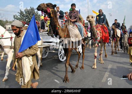 (140114) -- LAHORE, Jan. 14, 2014 (Xinhua) -- Pakistani Muslims ride on camels as they take part in a parade during celebrations marking Eid-e-Milad-un-Nabi, the birthday of Prophet Mohammed, in eastern Pakistan s Lahore on Jan. 14, 2014. Muslims across the world celebrated the birth of the Prophet Mohammed on 12 Rabil ul Awal, a month of the Muslim calendar. (Xinhua/Sajjad) PAKISTAN-LAHORE-RELIGION PUBLICATIONxNOTxINxCHN   Lahore Jan 14 2014 XINHUA Pakistani Muslims Ride ON Camels As They Take Part in a Parade during celebrations marking Oath e Milad UN Nabi The Birthday of Prophet Mohammed i Stock Photo