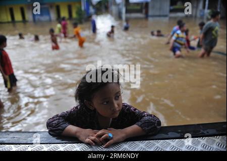 (140122) -- JAKART, 22. Januar 2014 (Xinhua) -- Ein Mädchen wird an einer überfluteten Bushaltestelle in Jakarta, Indonesien, 22. Januar 2014 gesehen. In der indonesischen Hauptstadt Jakarta haben einige der Vertriebenen begonnen, ihre Häuser zu säubern, während die Überschwemmung zurückgeht, aber sie zögern immer noch, nachts zurückzukehren, so die Beamten. (Xinhua/Zulkarnain) (zjl) INDONESIA-JAKARTA-FLOOD PUBLICATIONxNOTxINxCHN 22. Januar 2014 XINHUA A Girl IS Lakes AN einer überfluteten Bushaltestelle in Jakarta Indonesien 22. Januar 2014 in der indonesischen Hauptstadt Jakarta einige der vertriebenen Prominenten haben begonnen, Home t zurückzugeben Stockfoto