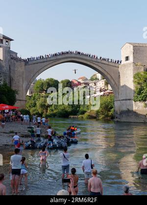 Jemand springt von Stari Most (Alte Brücke), während die Leute beobachten, dass dies ein Ritus der Durchfahrt in Mostar, Bosnien und Herzegowina, am 25. August 2023 ist. Stockfoto