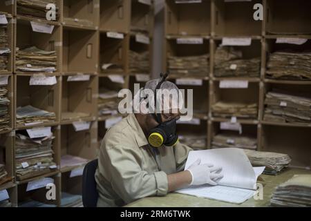 GUATEMALA CITY, Jan. 29, 2014 (Xinhua) -- A worker compiles and archives documents at the Historical Archive of the National Police (AHPN, for its acronym in Spanish), in Guatemala City, capital of Guatemala, on Jan. 29, 2014. The AHPN was found by chance on 2005 in an old explosives deposit of the National Civil Deposit (PNC). The archive possesses around 80 million of sheets covering a date range from 1881 to 1997, when the National Police ceased to exist and the PNC came to be. The documents revealed the way in which the National Police operated during the armed conflict in Guatemala (1960- Stock Photo