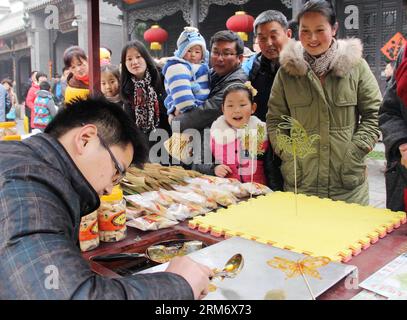 (140202) -- ZAOZHUANG,  (Xinhua) -- People gather to watch sugar painting at a temple fair in celebration of Chinese lunar new year in ancient city of Taierzhuang in Zaozhuang City, east China s Shandong Province, Feb. 2, 2014. (Xinhua/Zhang Yanxin) (lfj) CHINA-LUNAR NEW YEAR-CELEBRATIONS (CN) PUBLICATIONxNOTxINxCHN   Zaozhuang XINHUA Celebrities gather to Watch Sugar Painting AT a Temple Fair in Celebration of Chinese Lunar New Year in Ancient City of Taierzhuang in Zaozhuang City East China S Shan Dong Province Feb 2 2014 XINHUA Zhang   China Lunar New Year celebrations CN PUBLICATIONxNOTxIN Stock Photo