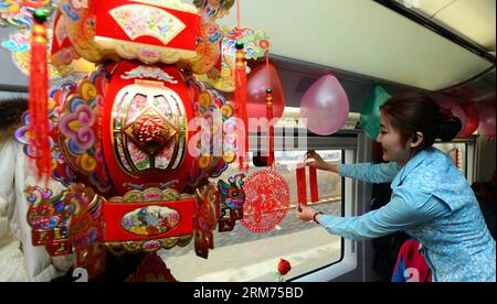 (140214) -- QINGDAO, Feb. 14, 2014 (Xinhua) -- A train attendant hangs festival lanterns and lantern riddles on G224 high-speed train from Qingdao of east China s Shandong Province to east China s Shanghai, Feb. 14, 2014. The G224 train crew prepared Tangyuan and some activities for the passengers to celebrate the Chinese Lantern Festival on Friday. (Xinhua/Fan Changguo) (af) CHINA-QINGDAO-LANTERN FESTIVAL ON HIGH-SPEED RAIL(CN) PUBLICATIONxNOTxINxCHN   Qingdao Feb 14 2014 XINHUA a Train attendant Hangs Festival Lanterns and Lantern riddles ON  High Speed Train from Qingdao of East China S Sha Stock Photo