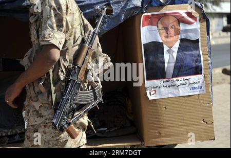 (140226) -- SANAA, Feb. 26, 2014 (Xinhua) -- A soldier passes by a poster of Yemeni President Abd-Rabbu Mansour Hadi on a street in Sanaa, Yemen, on Feb. 26, 2014. (Xinhua/Mohammed Mohammed) YEMEN-SANAA-UN RESOLUTION-GOVERNMENT-TRANSITION PUBLICATIONxNOTxINxCHN   Sanaa Feb 26 2014 XINHUA a Soldier Pass by a Poster of Yemeni President Abd  Mansour Hadi ON a Street in Sanaa Yemen ON Feb 26 2014 XINHUA Mohammed Mohammed Yemen Sanaa UN Resolution Government TRANSITION PUBLICATIONxNOTxINxCHN Stock Photo