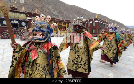 (140228) -- LHASA, Feb. 28, 2014 (Xinhua) -- Masked Tibetan Buddhists perform during a Cham dance ritual held to celebrate the upcoming Losar at the Tsurphu Monastery in Doilungdeqen County of Lhasa, capital of southwest China s Tibet Autonomous Region, Feb. 28, 2014. The Cham dance is a ritual performed by Tibetan Buddhist monks to exorcise evil spirits. The dancers wear masks of various animals and mythical figures as they perform to the accompaniment of religious music. At the Tsurphu Monastery, a main base of the Kagyu school in Tibetan Buddhism, the Cham dance is usually performed two day Stock Photo