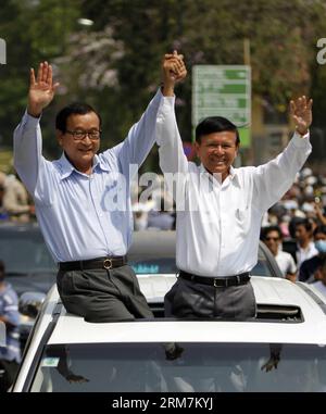 Sam Rainsy (L), leader of the opposition Cambodia National Rescue Party, and his deputy Kem Sokha appear at a rally near the Freedom Park in Phnom Penh, Cambodia, March 8, 2014. Hundreds of opposition-aligned trade union activists and workers illegally rallied on a street near the capital s Freedom Park on Saturday morning, calling for higher wages and release of 21 detained protesters. (Xinhua/Sovannara) CAMBODIA-PHNOM PENH-RALLY PUBLICATIONxNOTxINxCHN   Sat Rainsy l Leader of The Opposition Cambodia National Rescue Party and His Deputy Kem Sokha appear AT a Rally Near The Freedom Park in Phn Stock Photo