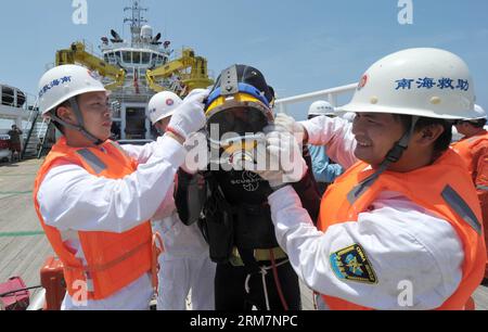 (140311) -- SOUTH CHINA SEA RESCUE 101 , March 11, 2014 (Xinhua) -- Members of a Chinese emergency response team put on diving suit on the rescue vessel South China Sea Rescue 101 , at the possible crash site of missing Malaysia Airlines flight MH370. Five Chinese rescue vessels, including South China Sea Rescue 115 and South China Sea Rescue 101 , have all arrived at the possible crash site as of Tuesday and immediately started the search mission for missing flight MH370. (Xinhua/Zhao Yingquan) (zgp) SOUTH CHINA SEA RESCUE 101-MISSING FLIGHT MH370-SALVAGE MISSION (CN) PUBLICATIONxNOTxINxCHN Stock Photo