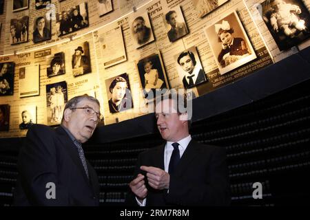 JERUSALEM, March 12, 2014 (Xinhua) -- Visiting British Prime Minister David Cameron (R) speaks with Yad Vashem Chairman Avner Shalev in the Hall of Names during his visit to the Yad Vashem Holocaust Memorial museum in Jerusalem, on March 12, 2014. British Prime Minister David Cameron on Wednesday called on the Israeli Knesset (parliament) to reach out for historic peace with Palestinians, during his first visit to Israel as prime minister. British Prime Minister David Cameron is on a two-day visit to Israel and Palestinian territories. (Xinhua/POOL/Gali Tibbon)(bxq) MIDEAST-ISRAEL-CAMERON-VISI Stock Photo