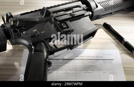 AR-15 mit gemeinfreiem Hintergrundprüfformular und Stift in der Nähe Stockfoto