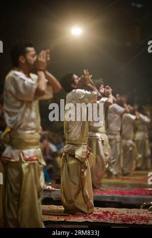 (140325) -- VARANASI, 25. März 2014 (Xinhua) -- Priester führen Ganges Aarti in Varanasi auf, einer alten und hinduistischen heiligen Stadt am Ufer des Ganges, Indien, 25. März 2014. Die Ganges Aarti ist die rituelle Zeremonie der Hindus, die ihr Engagement für die Flussgötter zeigt. Aufgrund seiner Dressings und seines einzigartigen Stils ist die großartige Veranstaltung zu einem muss in Varanasi geworden und zieht jeden Tag Touristen aus der ganzen Welt an. (Xinhua/Zheng HUANSONG) INDIA-VARANASI-GANGA AARTI PUBLICATIONxNOTxINxCHN Varanasi März 25 2014 XINHUA Priester führen Ganges Aarti in Varanasi zu Alt und H Stockfoto