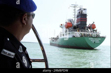 (140423) -- PORT KLANG, April 23, 2014 (Xinhua) -- A policeman looks at the robbed Japanese vessel in Port Klang, Malaysia, on April 23, 2014. A Japanese vessel was robbed of two million litres of diesel by five men about 16 nautical miles from Pulau Ketam, a small island off the coast of Port Klang, Malaysia, with three of its 18 crew also abducted by the robbers on its way from Singapore to Myanmar, local media reported Wednesday. (Xinhua) MALAYSIA-PORT KLANG-JAPANESE VESSEL-ROBBERY PUBLICATIONxNOTxINxCHN   Port Sound April 23 2014 XINHUA a Policeman Looks AT The robbed Japanese Vessel in Po Stock Photo