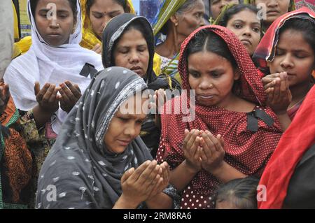 (140424) -- DHAKA, April 24, 2014 (Xinhua) -- Relatives of victims pray at the site of Rana Plaza building collapse during a commemoration in Savar, on the outskirts of Dhaka, Bangladesh, April 24, 2014. Bangladesh held ceremonies on Thursday to commemorate the victims of the country s worst-ever industrial tragedy which left at least 1,135 people dead, mostly garment workers.(Xinhua/Shariful Islam)(zhf) BANGLADESH-DHAKA-BUILDING COLLAPSE-COMMEMORATION PUBLICATIONxNOTxINxCHN   Dhaka April 24 2014 XINHUA Relatives of Victims Pray AT The Site of Rana Plaza Building Collapse during a Commemoratio Stock Photo