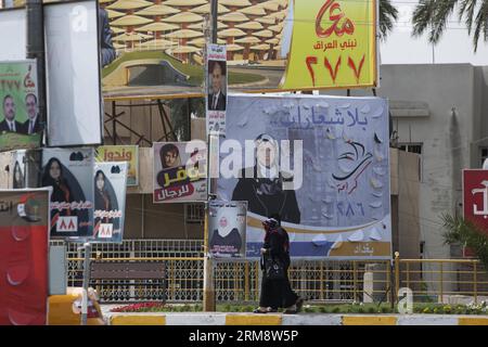 (140427) -- BAGHDAD, April 26, 2014 (Xinhua) -- Iraqi people walk past giant posters of candidates in downtown Baghdad, capital of Iraq, on April 26, 2014, ahead of the country s parliamentary election which will be held on April 30. This is the first parliamentary election of the country since the U.S. troops withdrew in late 2011. (Xinhua/Cui Xinyu) (lyx) IRAQ-BAGHDAD-ELECTION PUBLICATIONxNOTxINxCHN   Baghdad April 26 2014 XINHUA Iraqi Celebrities Walk Past Giant Posters of Candidates in Downtown Baghdad Capital of Iraq ON April 26 2014 Ahead of The Country S Parliamentary ELECTION Which wil Stock Photo